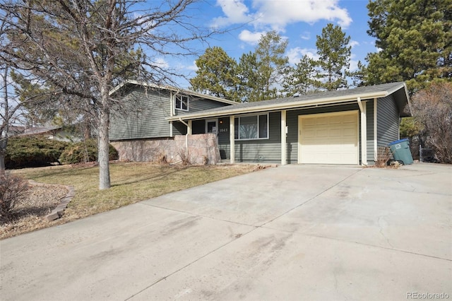 tri-level home featuring a garage and a front yard