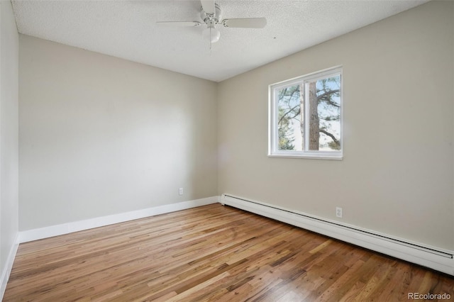 unfurnished room with light hardwood / wood-style flooring, ceiling fan, a baseboard radiator, and a textured ceiling