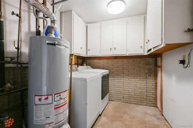 laundry room featuring cabinets, water heater, and independent washer and dryer