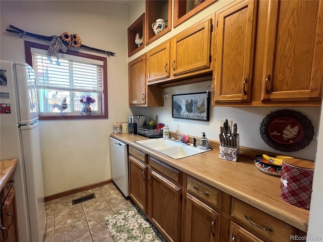 304 Cowan Rd, Bailey, CO 80421 - kitchen with white appliances, a sink, brown cabinets, light countertops, and light tile patterned flooring