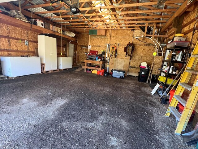 304 Cowan Rd, Bailey, CO 80421 - garage featuring fridge and a garage door opener