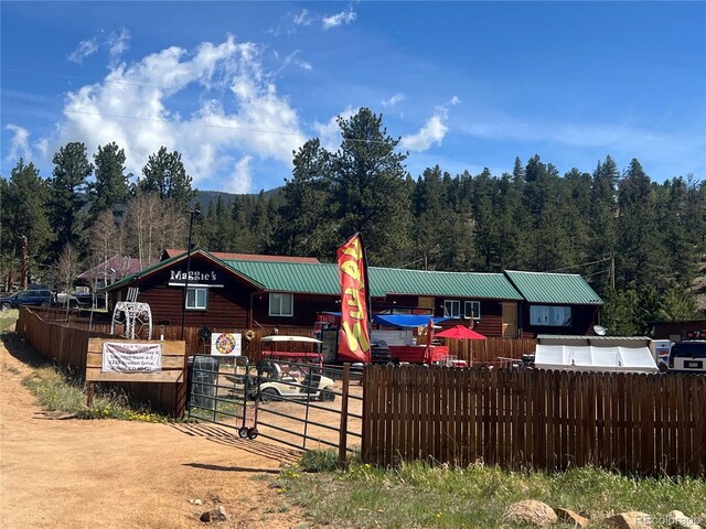 304 Cowan Rd, Bailey, CO 80421 - view of front facade featuring a wooded view and metal roof