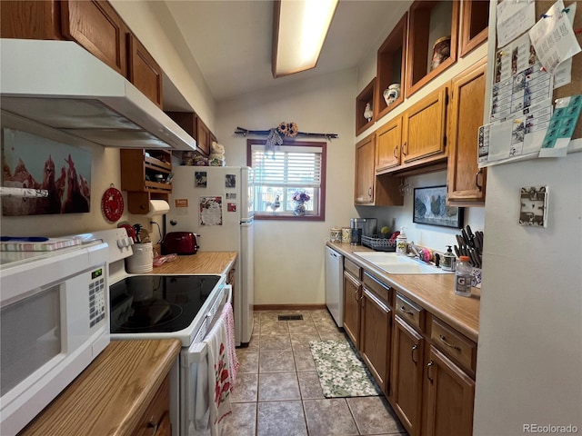 304 Cowan Rd, Bailey, CO 80421 - kitchen featuring white appliances, under cabinet range hood, a sink, light countertops, and light tile patterned floors