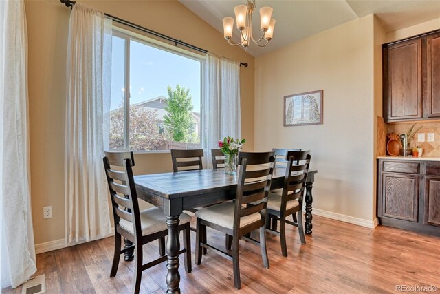 3470 Daydreamer Dr, Colorado Springs, CO 80908 - dining room with light wood-type flooring, a chandelier, and lofted ceiling