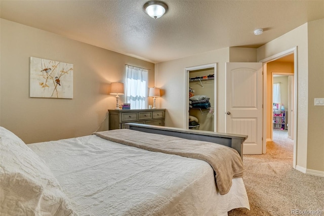 3470 Daydreamer Dr, Colorado Springs, CO 80908 - bedroom with light carpet, a textured ceiling, a walk in closet, and a closet