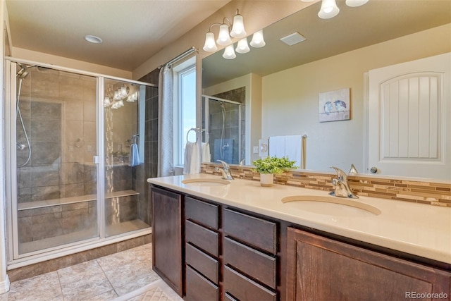 3470 Daydreamer Dr, Colorado Springs, CO 80908 - full bath featuring double vanity, a shower stall, backsplash, and tile patterned floors