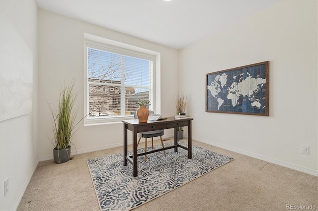 carpeted office space featuring baseboards