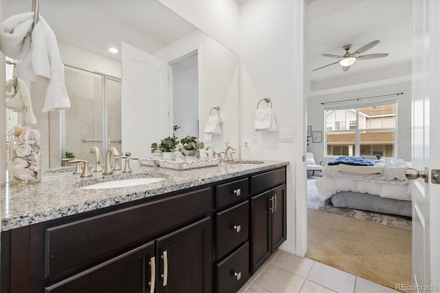 full bathroom featuring double vanity, connected bathroom, a sink, and tile patterned floors