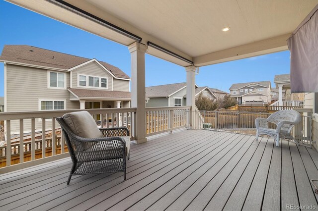 wooden terrace with a residential view