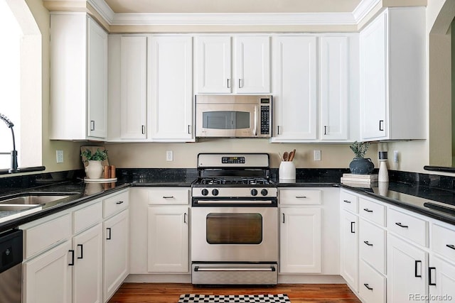 kitchen with sink, stainless steel appliances, and white cabinets