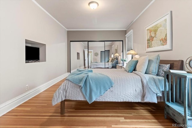 bedroom with hardwood / wood-style floors and ornamental molding