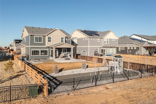 back of property with a patio and a playground