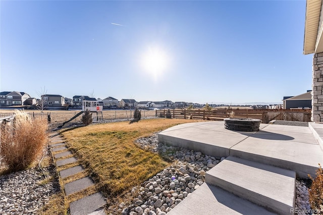 view of yard featuring an outdoor fire pit and a patio