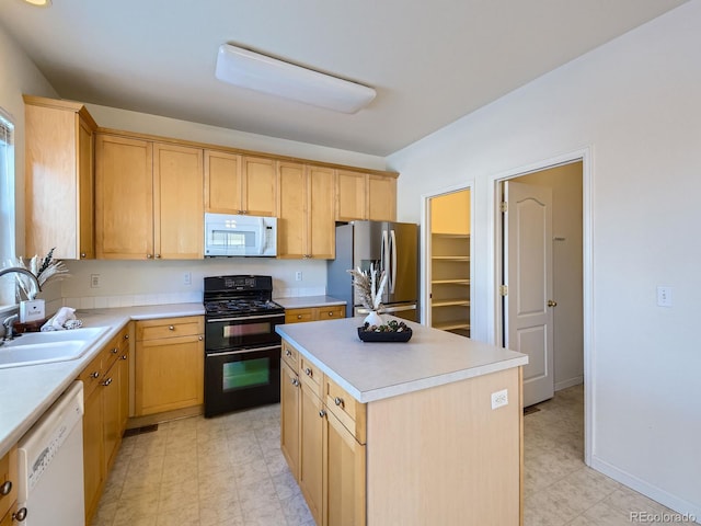 kitchen with white appliances, light brown cabinetry, a center island, and sink