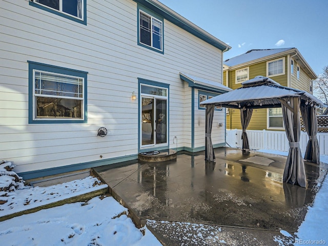 snow covered house featuring a gazebo