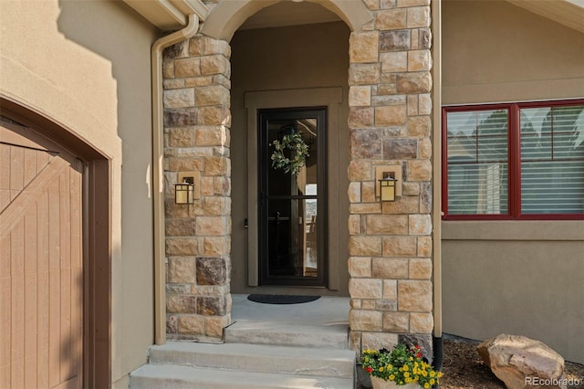 entrance to property with stucco siding and stone siding