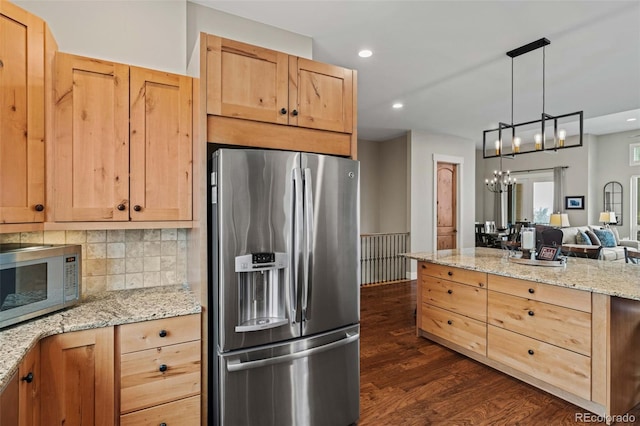 kitchen with dark wood-style floors, light brown cabinetry, and appliances with stainless steel finishes