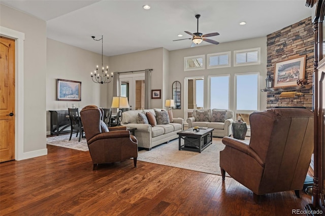 living area with baseboards, dark wood-style floors, recessed lighting, and ceiling fan with notable chandelier