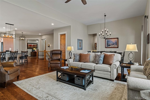 living area featuring recessed lighting, wood finished floors, and ceiling fan with notable chandelier