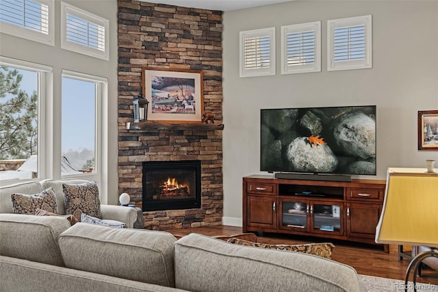 living room with dark wood-type flooring and a fireplace