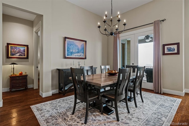 dining space featuring a chandelier, wood finished floors, and baseboards