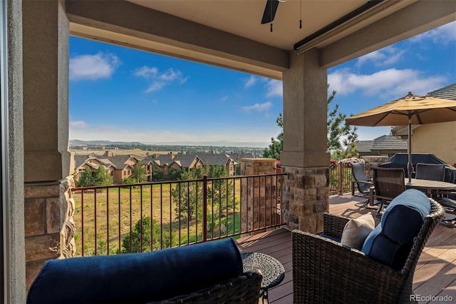 balcony featuring a ceiling fan and a residential view