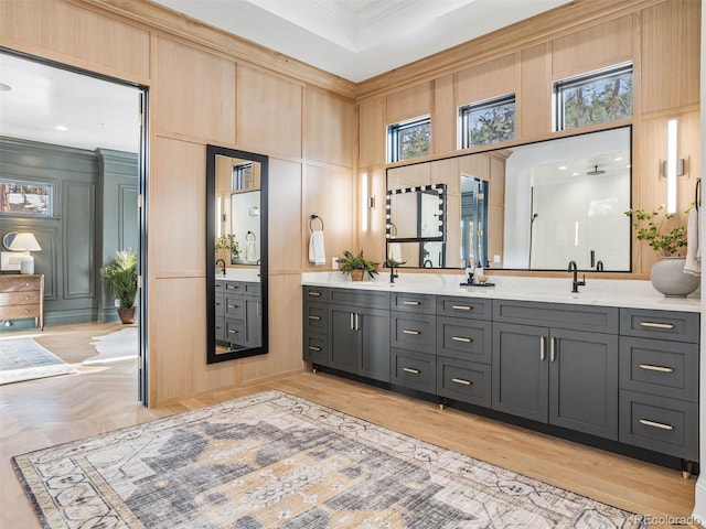 bathroom with a towering ceiling, ornamental molding, and vanity