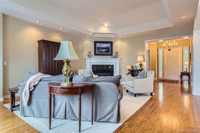 32 Silver Fox Cir, Greenwood Village, CO 80121 - living area with a chandelier, a fireplace, a tray ceiling, light wood-style floors, and recessed lighting