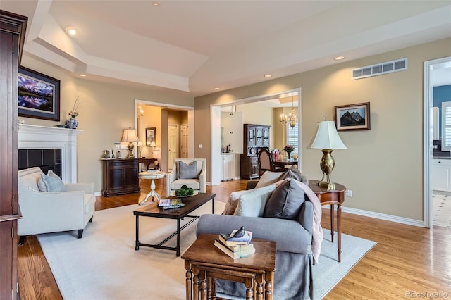 32 Silver Fox Cir, Greenwood Village, CO 80121 - living room featuring a chandelier, light wood finished floors, baseboards, a tile fireplace, and recessed lighting
