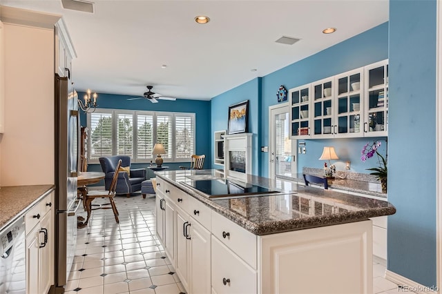 32 Silver Fox Cir, Greenwood Village, CO 80121 - kitchen featuring a kitchen island, dishwasher, black electric cooktop, glass insert cabinets, and ceiling fan