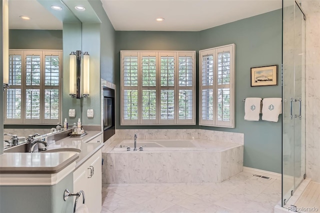 32 Silver Fox Cir, Greenwood Village, CO 80121 - bathroom with a garden tub, vanity, healthy amount of natural light, and recessed lighting