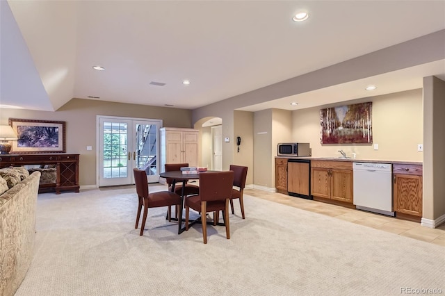 32 Silver Fox Cir, Greenwood Village, CO 80121 - dining space with arched walkways, light colored carpet, wet bar, recessed lighting, and baseboards