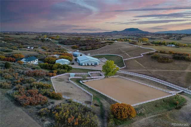 aerial view at dusk featuring a mountain view