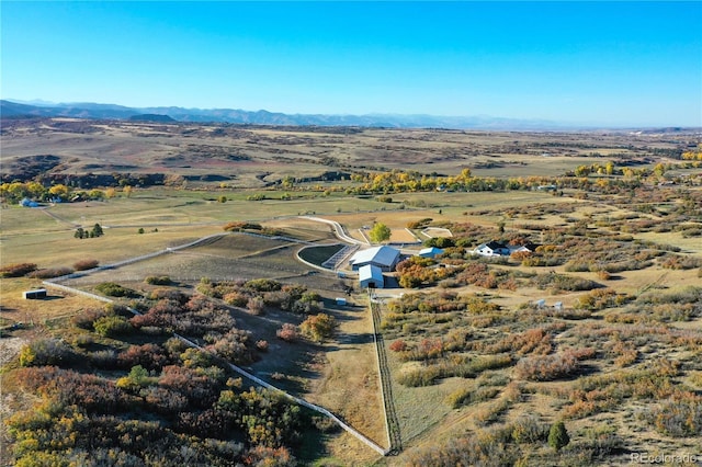 drone / aerial view featuring a mountain view and a rural view