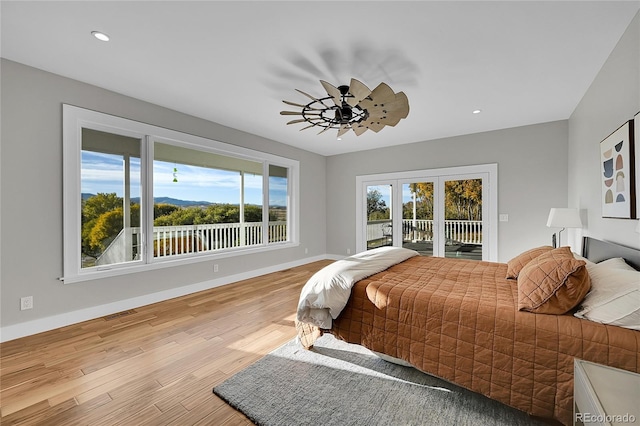 bedroom with access to exterior and light hardwood / wood-style flooring