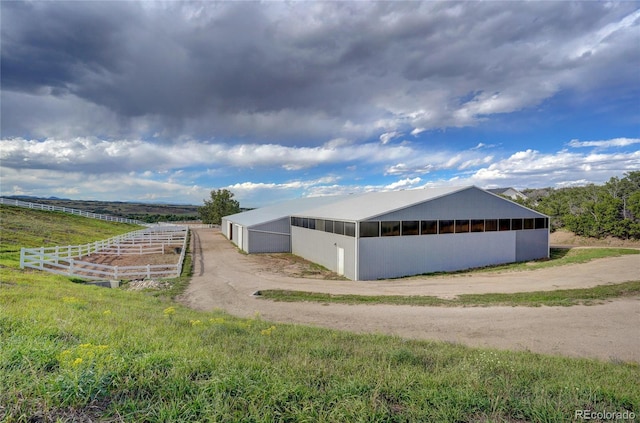 view of property exterior featuring an outbuilding and a rural view