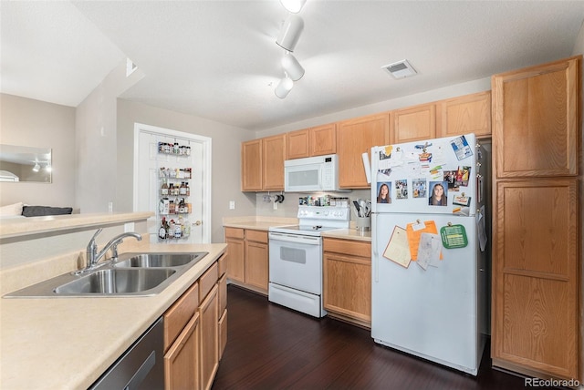 kitchen featuring white appliances, dark wood-style floors, visible vents, a sink, and light countertops