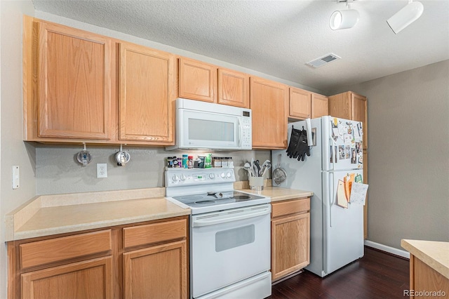 kitchen with visible vents, light countertops, dark wood-style floors, white appliances, and a textured ceiling