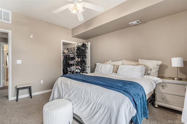 bedroom with visible vents, baseboards, carpet, and a spacious closet