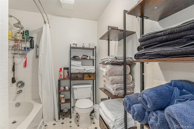 full bathroom with tile patterned floors, toilet, and shower / bath combo