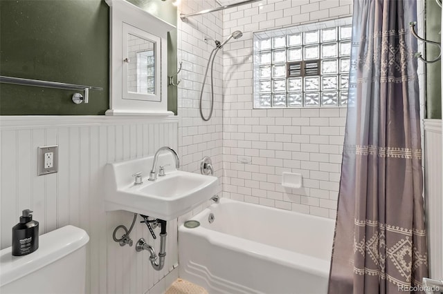 bathroom with toilet and shower / bath combination with curtain