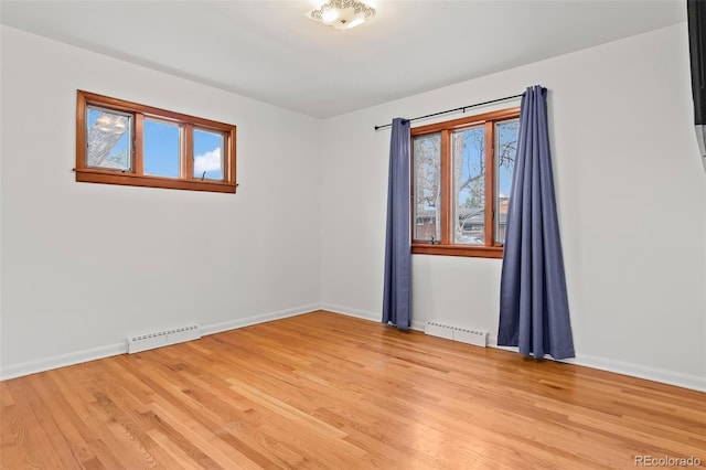 spare room featuring light hardwood / wood-style floors and baseboard heating