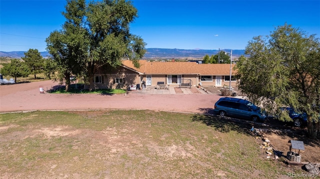 back of house with a mountain view