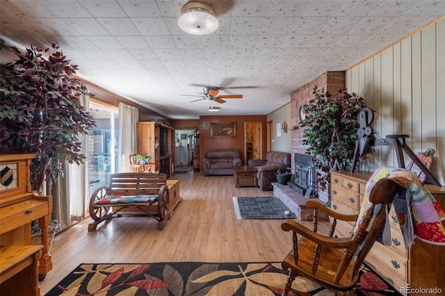 living room with a ceiling fan and wood finished floors