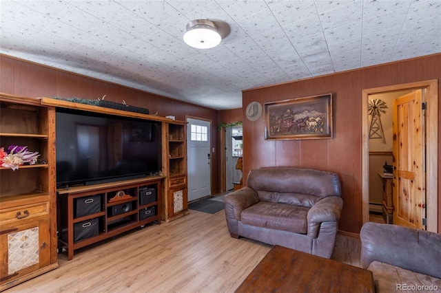 living room with light wood-style floors and wooden walls