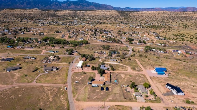 birds eye view of property featuring a mountain view