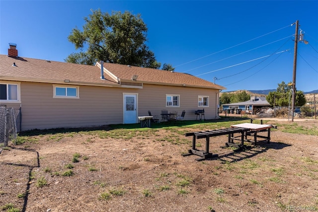 back of property featuring fence