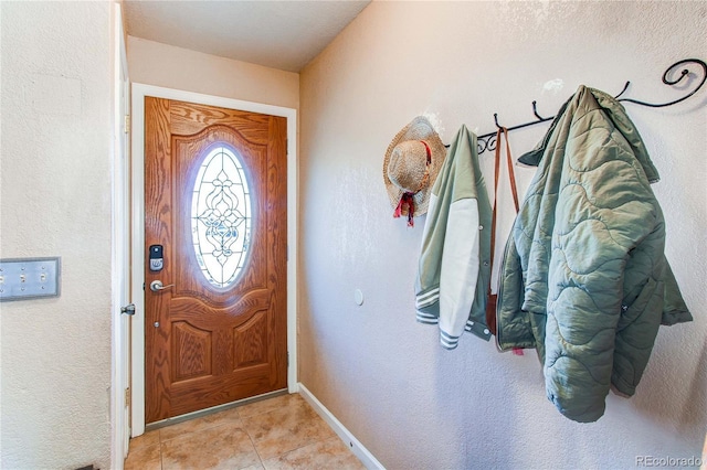 entrance foyer featuring light tile patterned floors and baseboards