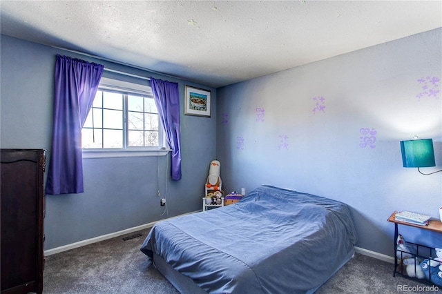 carpeted bedroom featuring a textured ceiling, visible vents, and baseboards