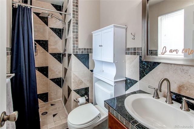 bathroom with toilet, a stall shower, tile walls, and vanity